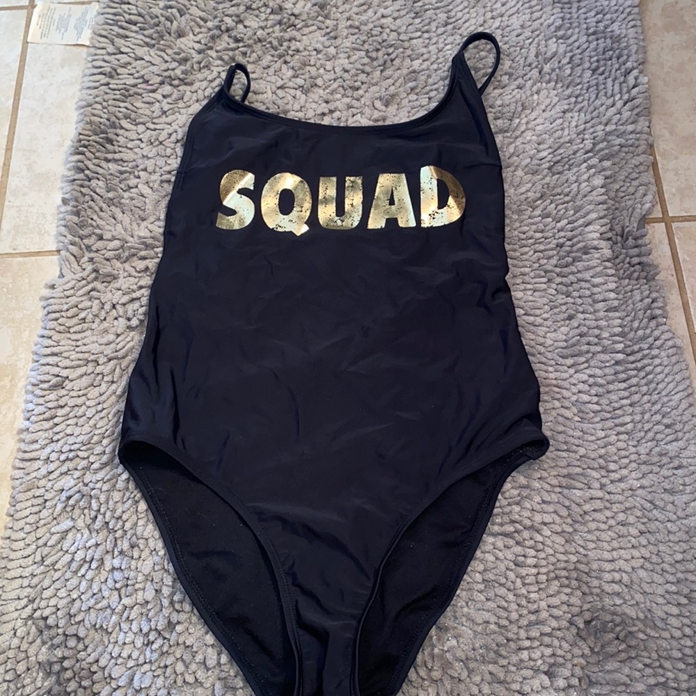 Black one price written in gold “SQUAD”. EUC